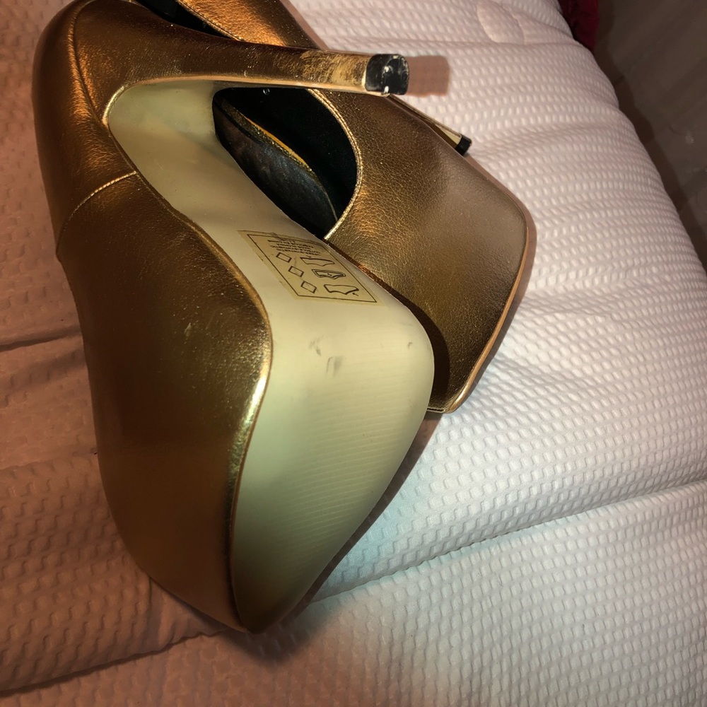 Gold platform heels.